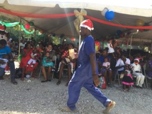 Christmas Party from Kay-O-Bois malnutrition program - Man walking with a santa hat on