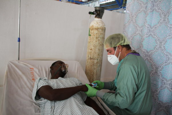 Doctor helping a patient with Covid