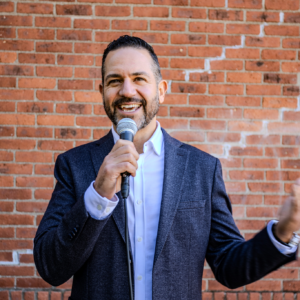 Michael Esposito speaking with a microphone as a workshop host about public speaking and building inner confidence as a leader in the hudson valley